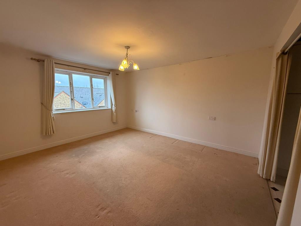 Living room with window and access into kitchen