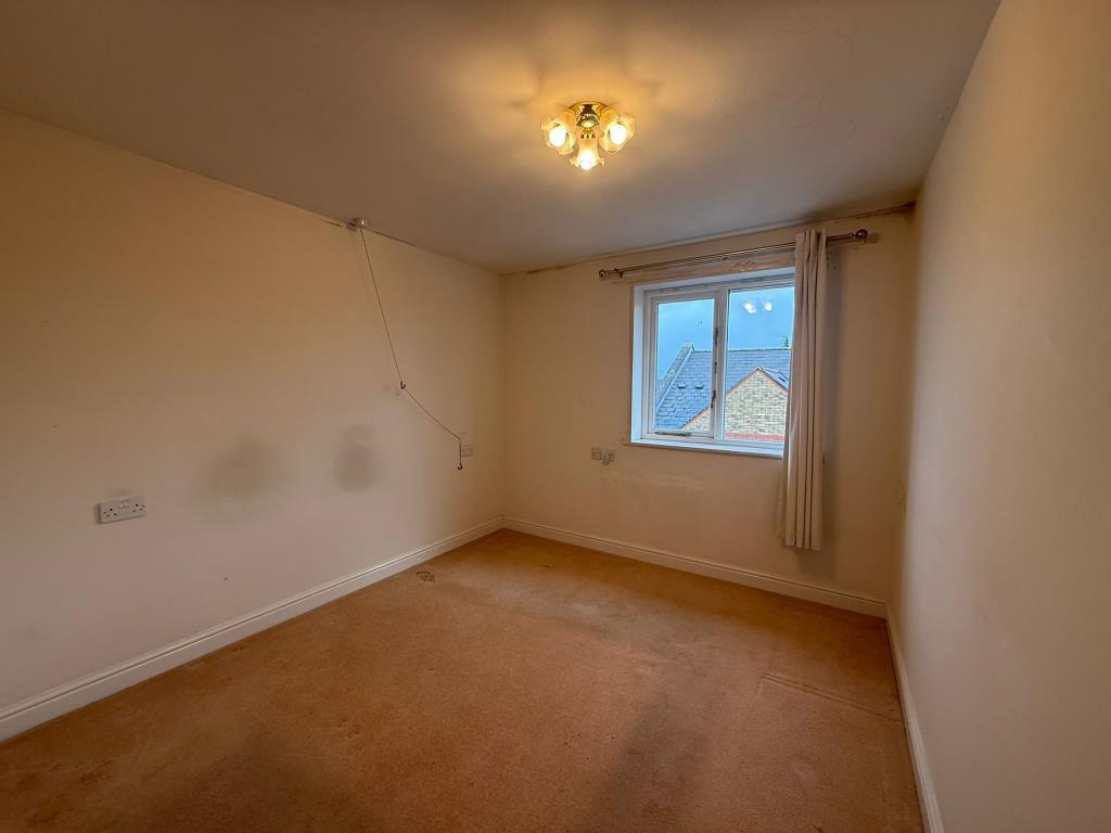 Carpeted main bedroom with window