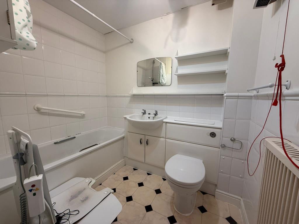 Tiled accessible 3 suite bathroom with chair lift