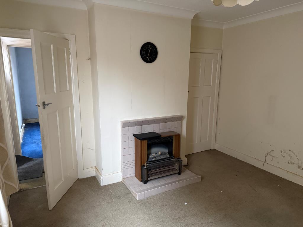 Living room with fireplace and door to front room