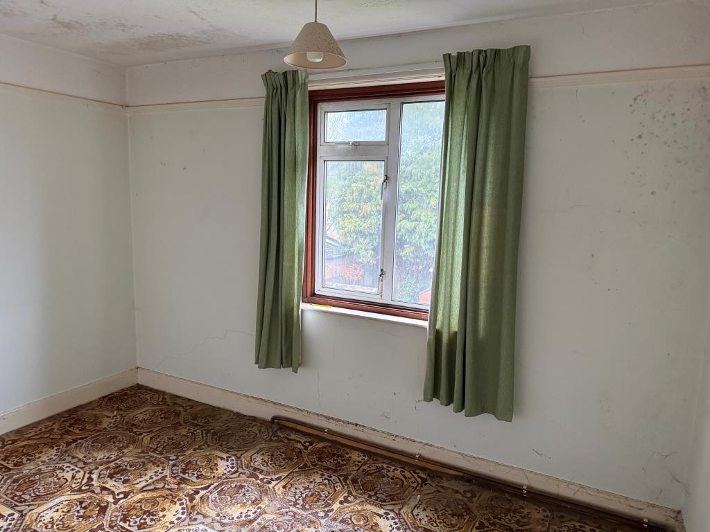 Second bedroom with rear view over garden