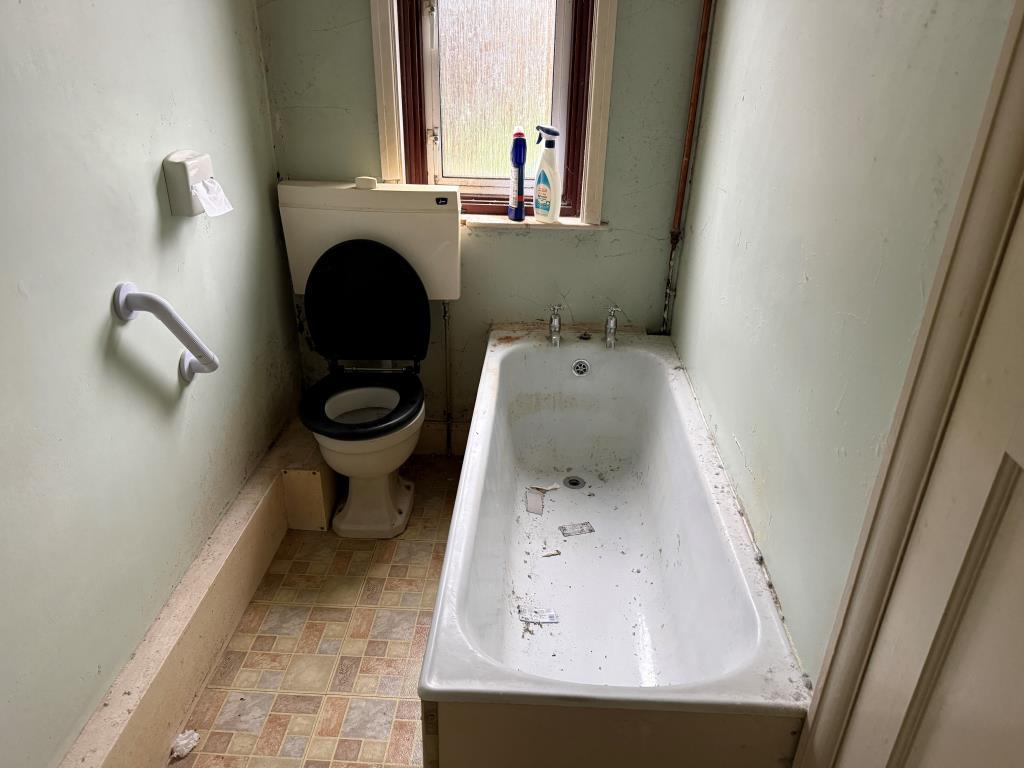 White bathroom suite on ground floor