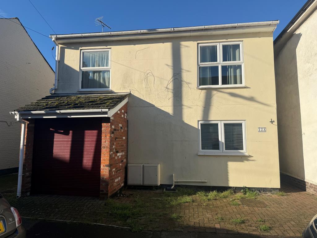 Front of property showing garage and parking