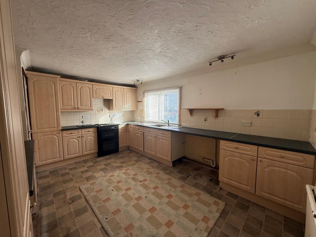 Tiled kitchen with window and space for appliances