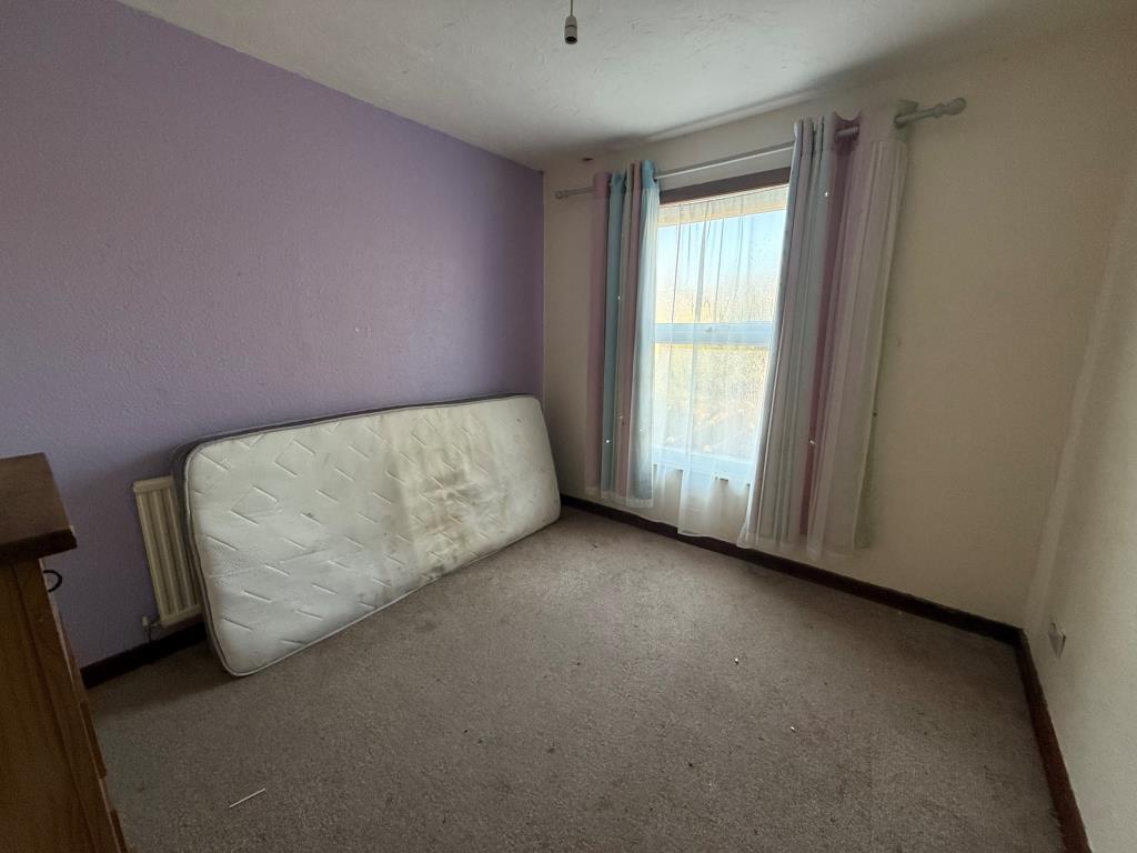 Carpeted 3rd bedroom with window and cupboard