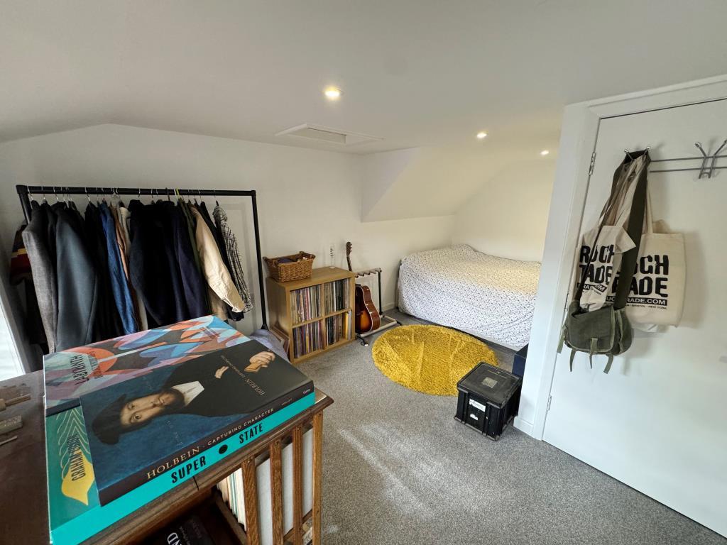 Bedroom with white painted walls and grey carpet
