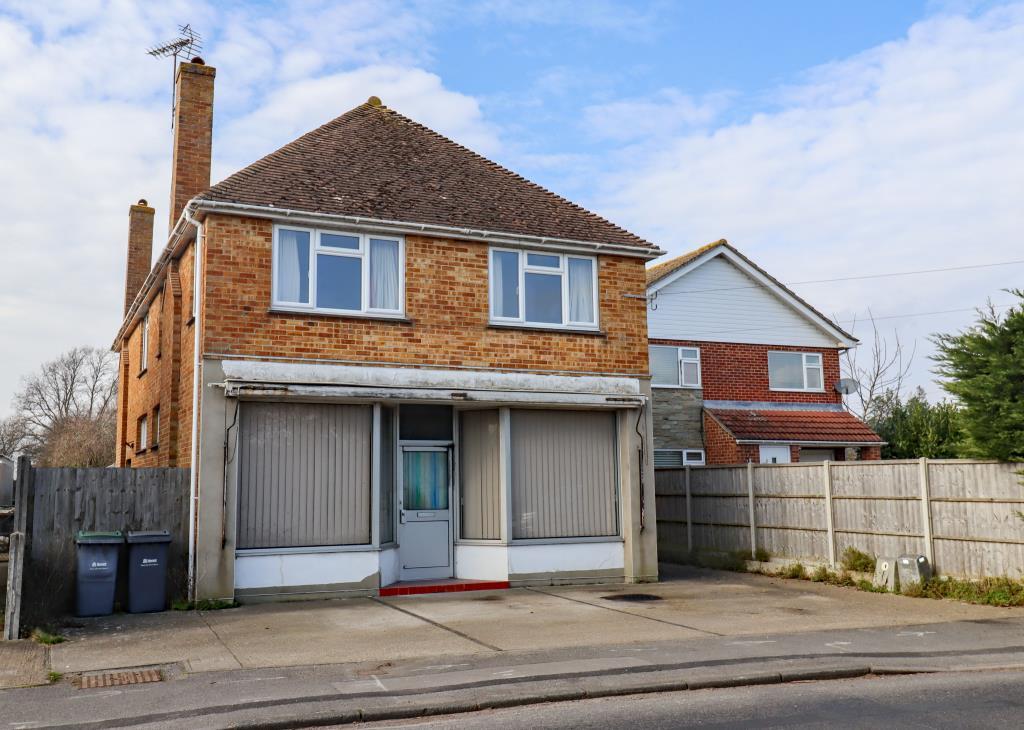 Detached building with parking area to front and s