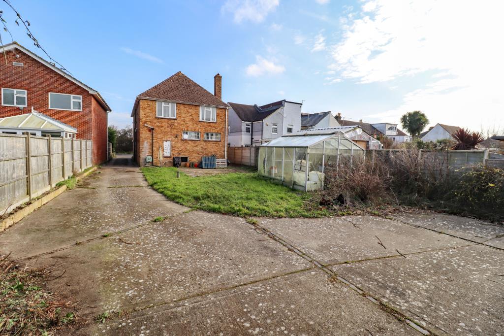 Garden with concrete drive and grass lawn to rear
