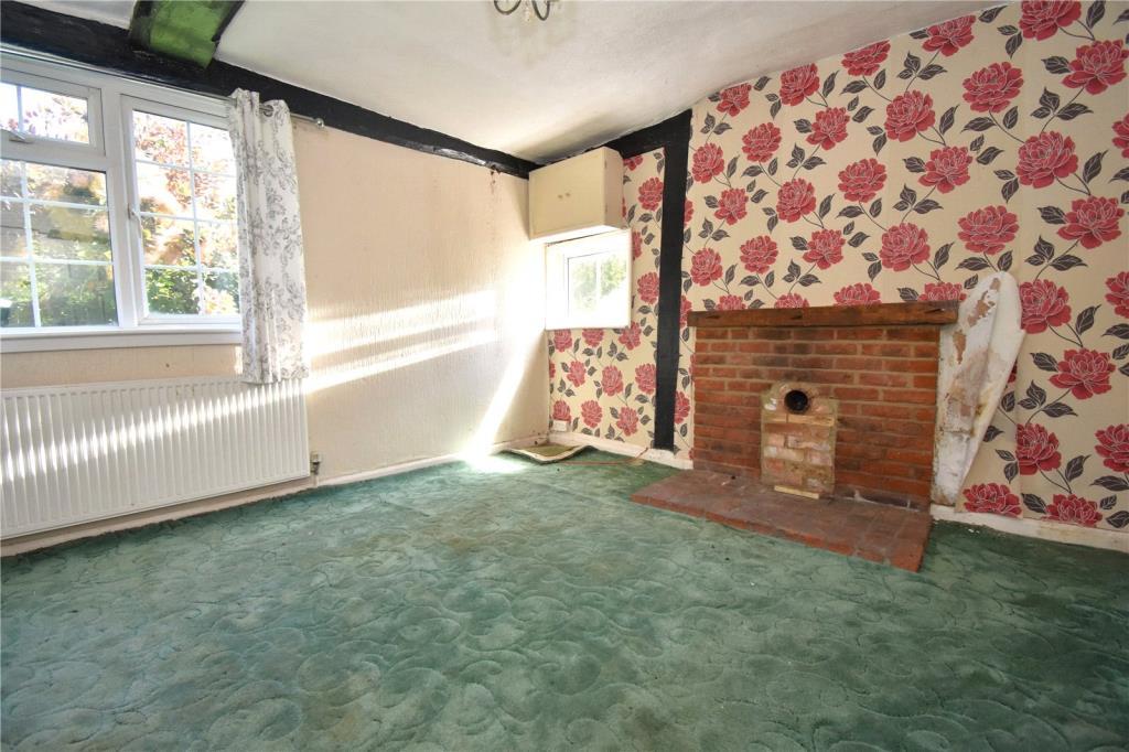 Sitting Room with fireplace and two windows