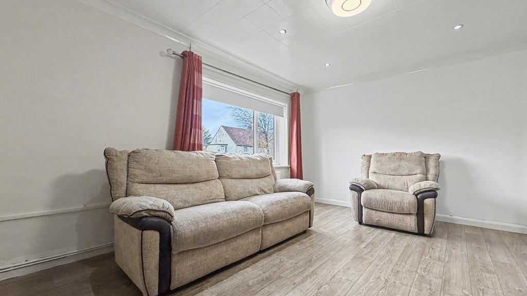 Bright, simply furnished living room with comfo...