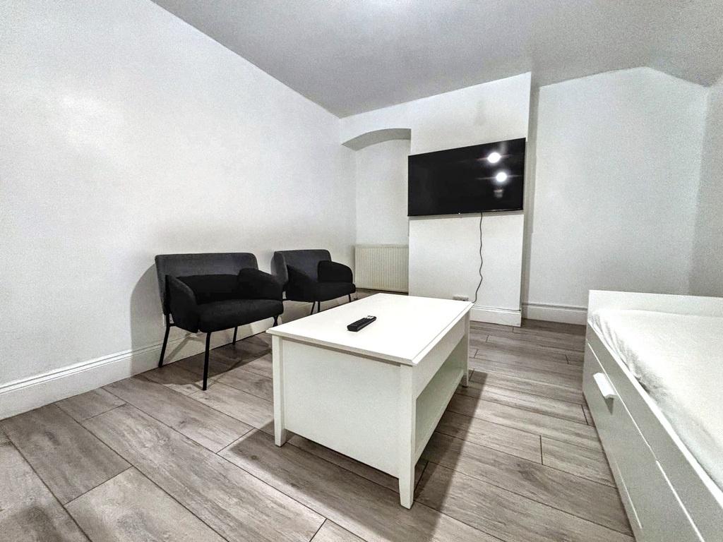 Bright, modern bedroom with clean white walls, ...