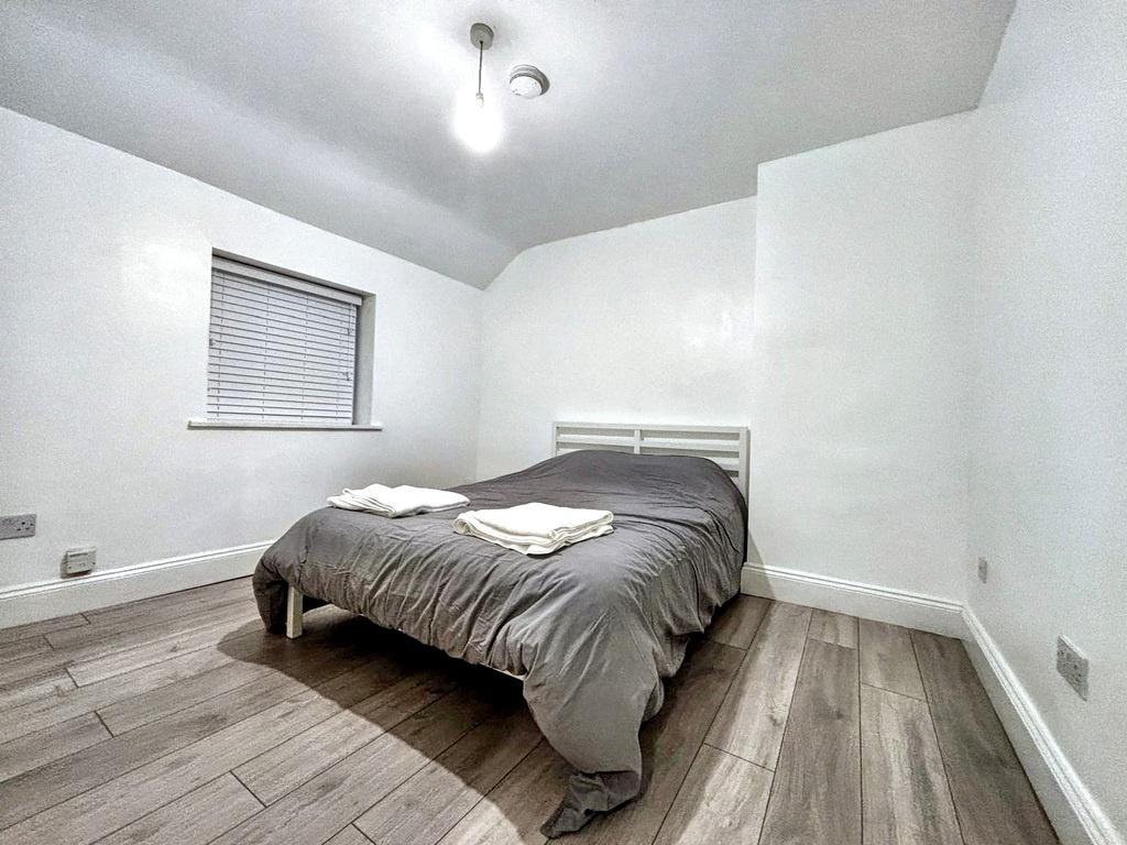 Bright, simply styled bedroom with a comfy doub...