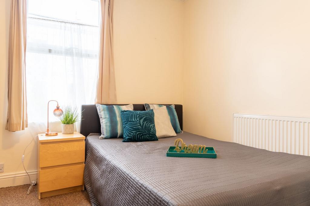 Bright, neatly presented bedroom with a comfort...