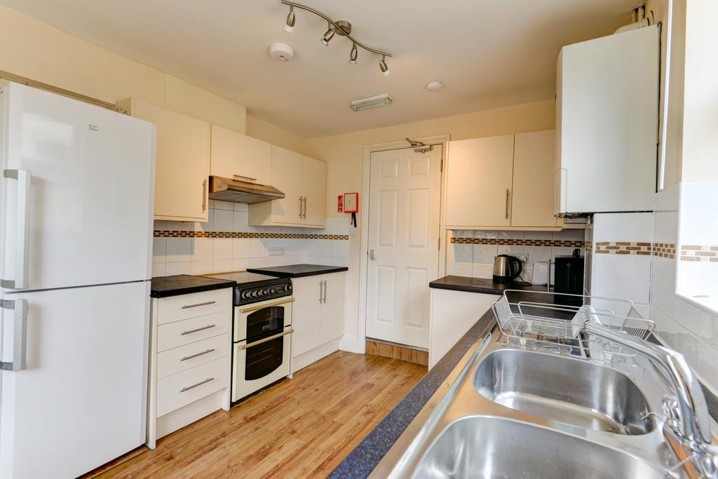 The image showcases a modern, well-maintained k...