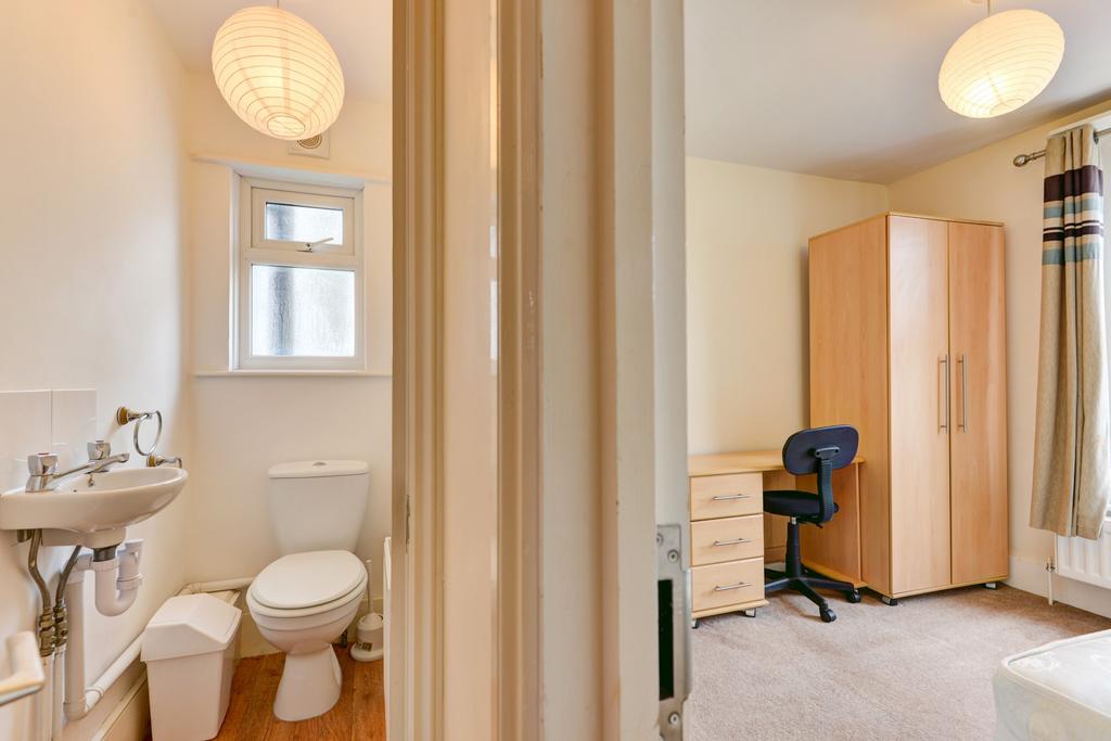 Bright, tidy bedroom with wardrobe, desk and ad...