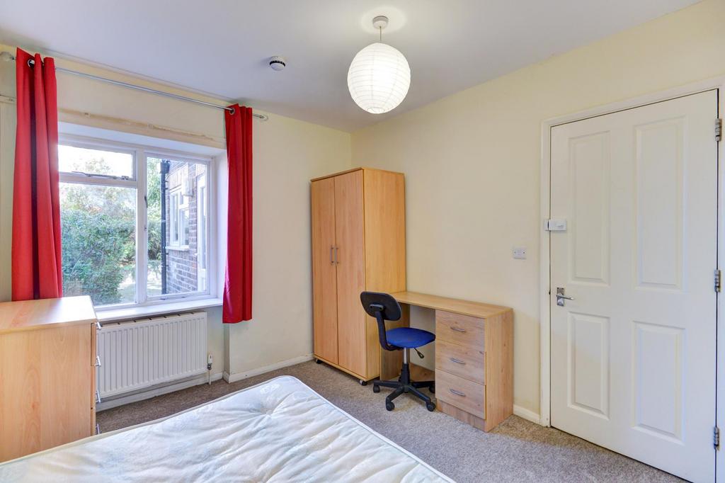 Bright, neatly presented bedroom with a large w...