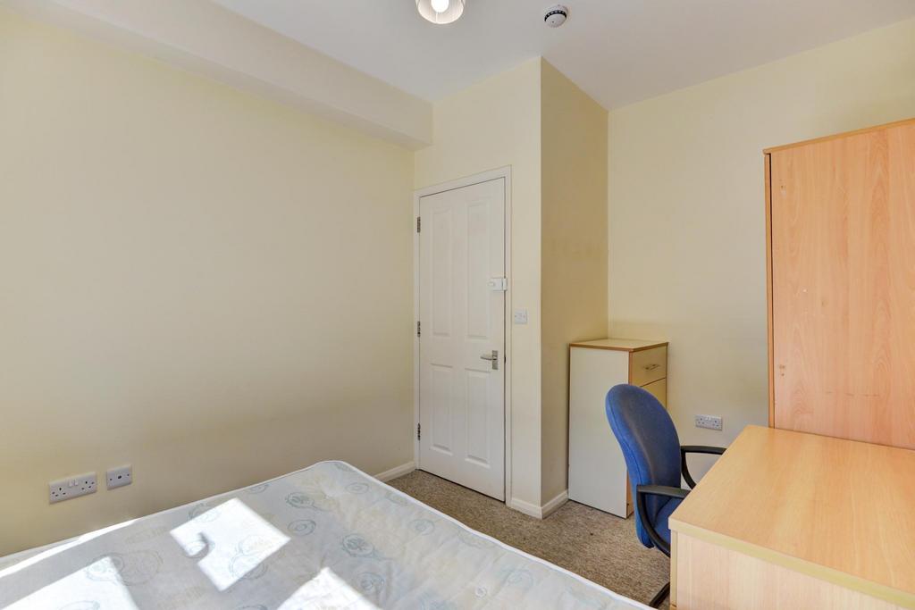 A well-lit double bedroom featuring a bed, ward...
