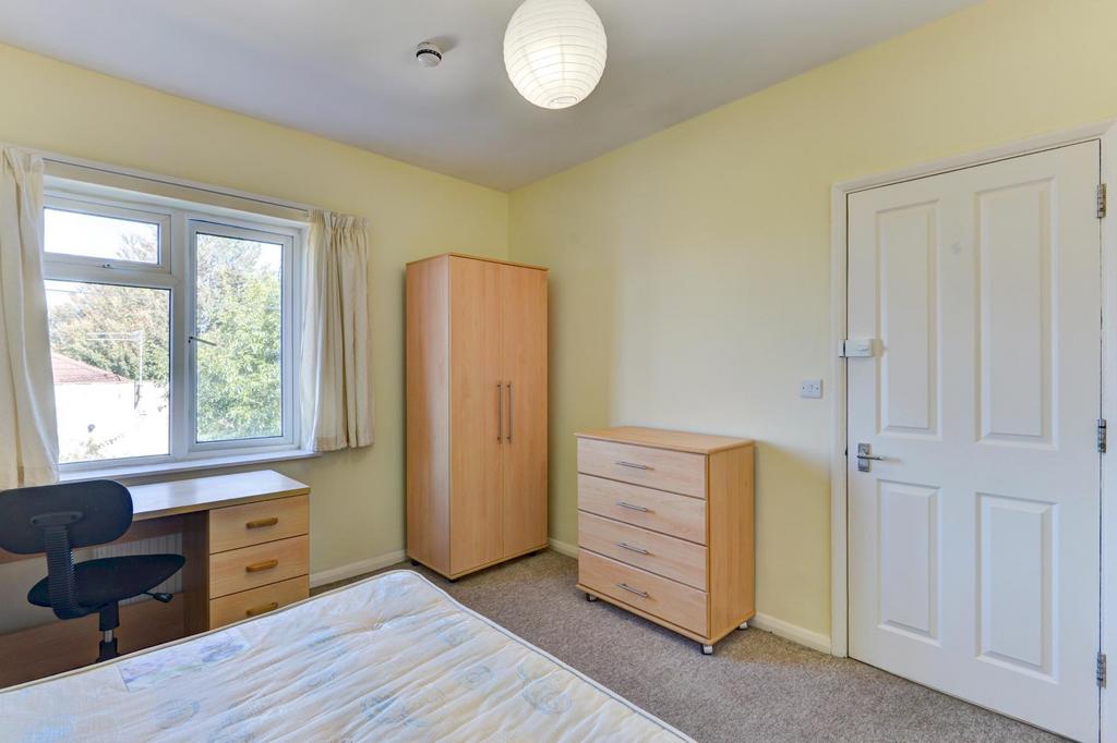 A bright and tidy bedroom featuring a large war...