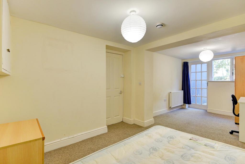 Bright, neutrally decorated double bedroom with...
