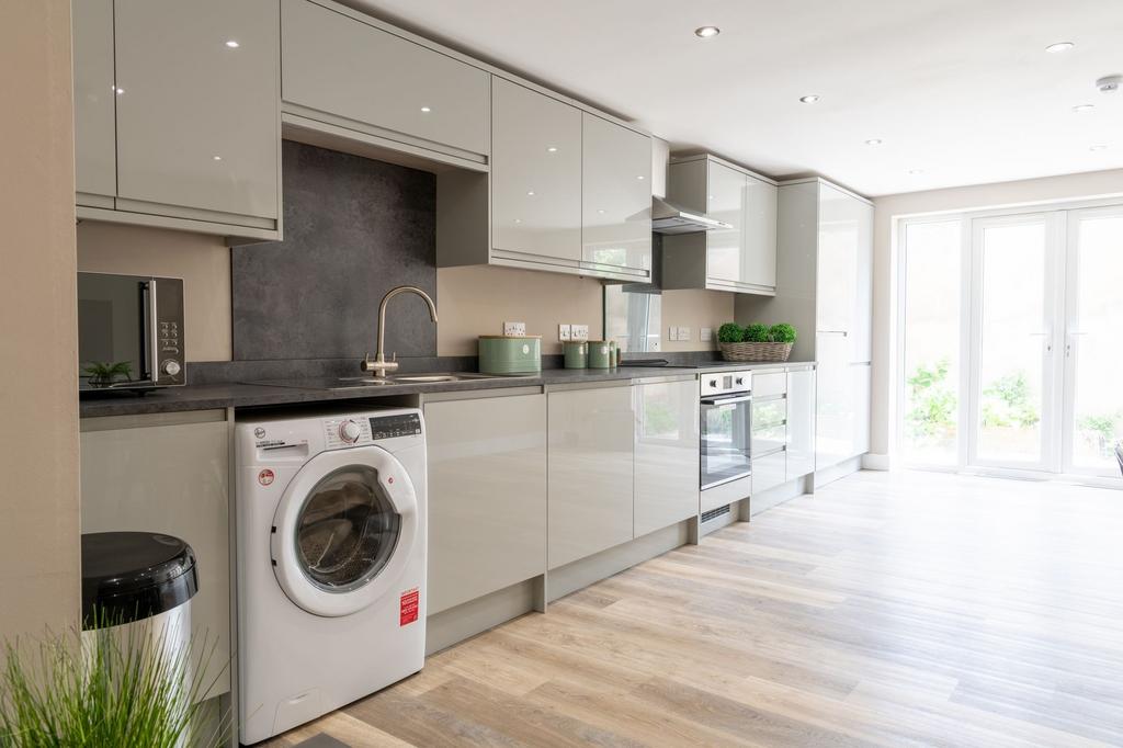 Bright modern kitchen with high-gloss cabinetry...