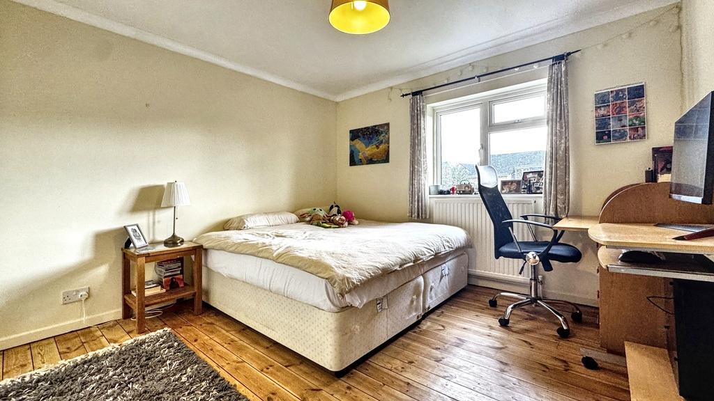 Bright, neatly presented bedroom with a comfort...