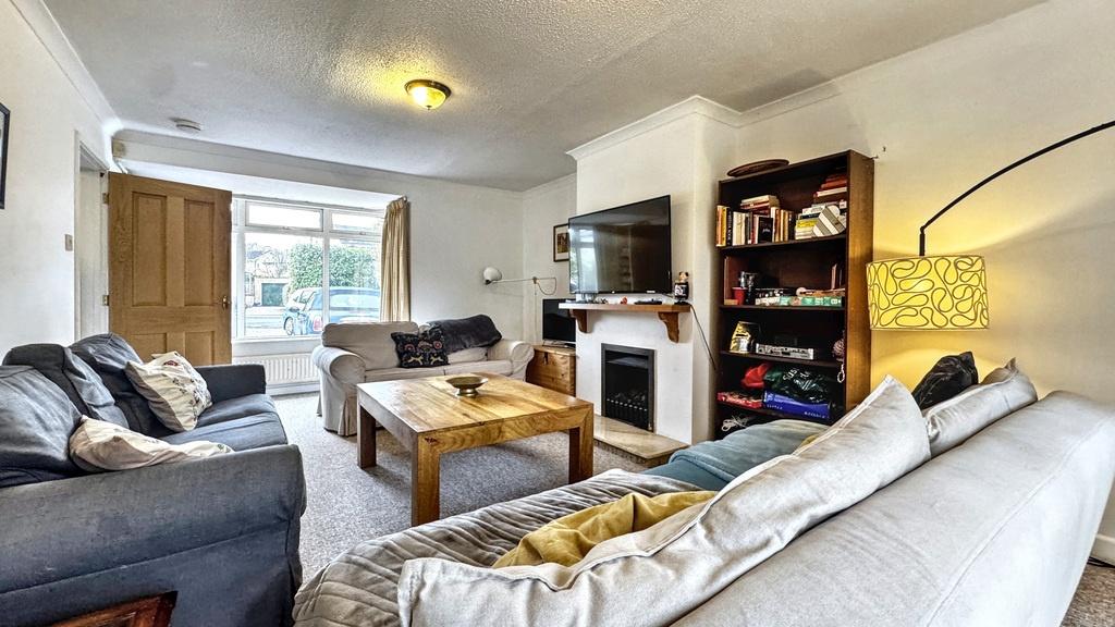 Bright, well-furnished living room with multipl...