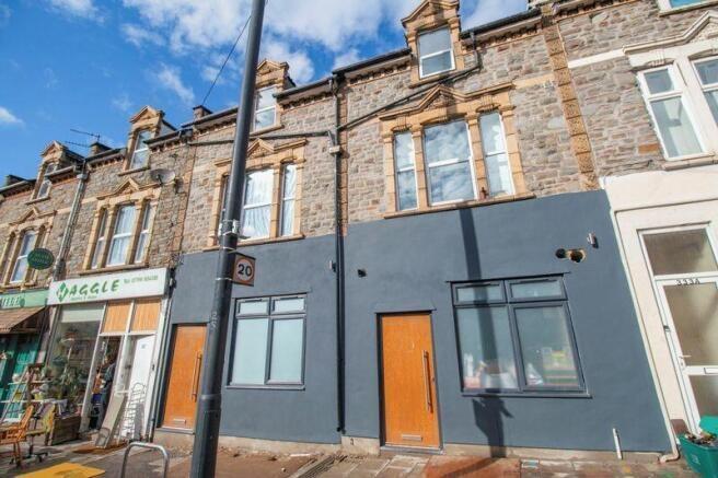 Street-facing terraced property with fresh dark...