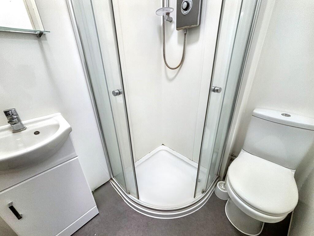 Bright, well-maintained bathroom with a corner ...
