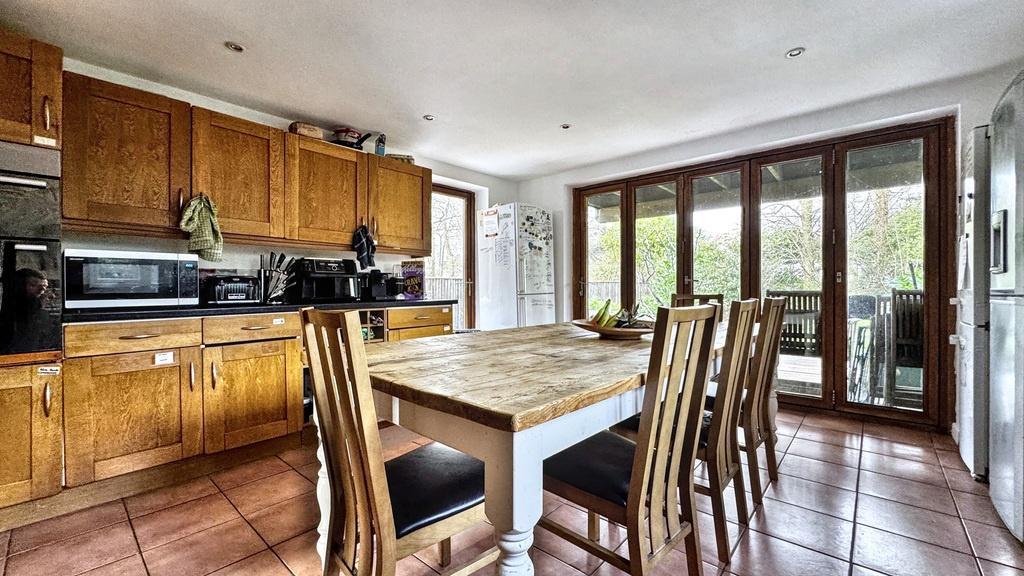 Bright country-style kitchen with a large woode...