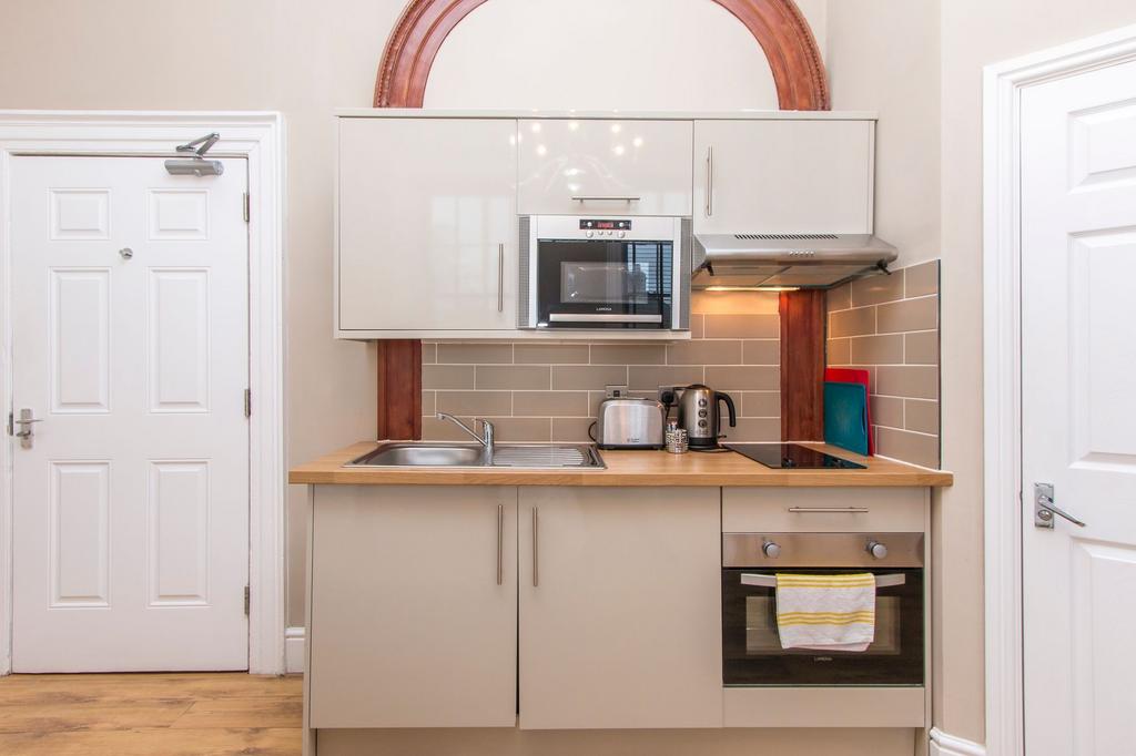 Bright, modern kitchenette with integrated oven...