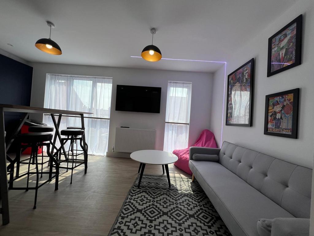 Bright modern living room with a comfy grey sof...