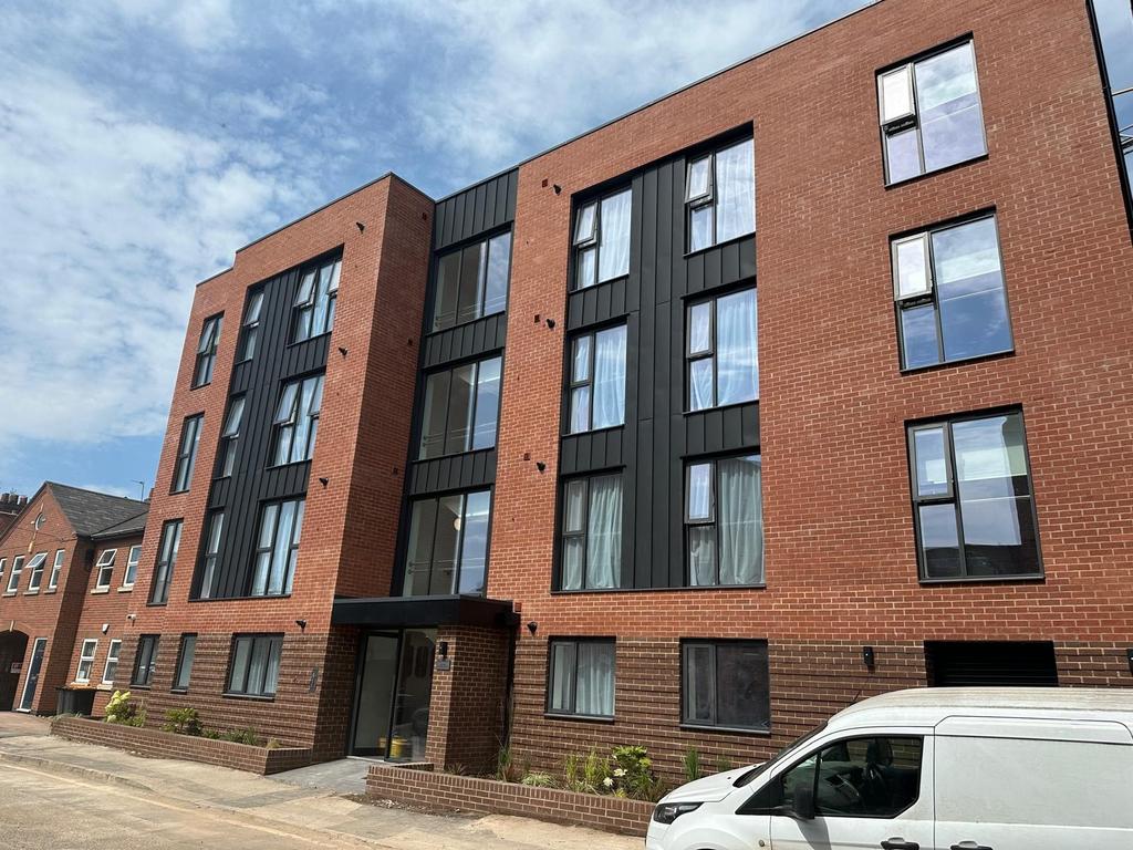 Modern red-brick apartment building with large ...