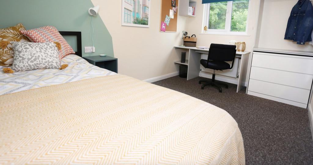This inviting double bedroom features a cozy la...