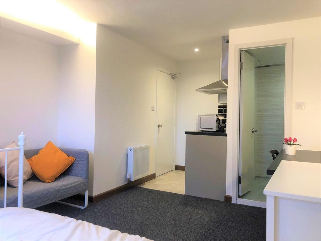 A neat and inviting single bedroom featuring a ...