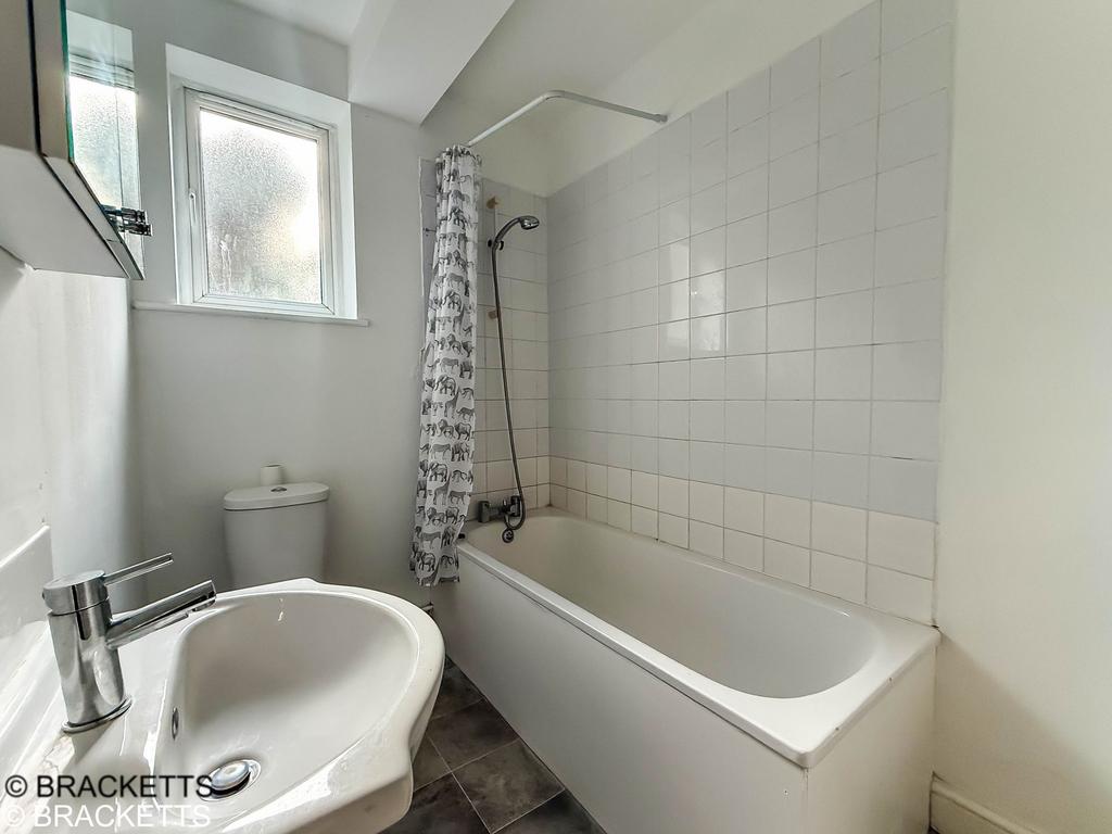 Bathroom with a shower over the bath