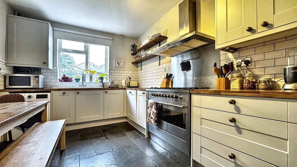 Bright, modern kitchen with white shaker-style ...