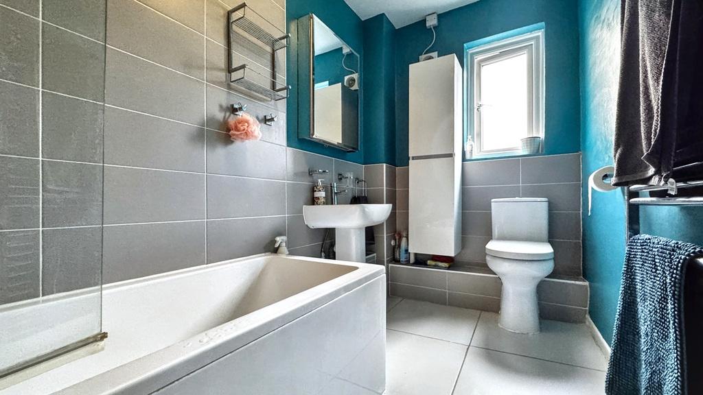 Bright, modern bathroom with a full-size bath, ...