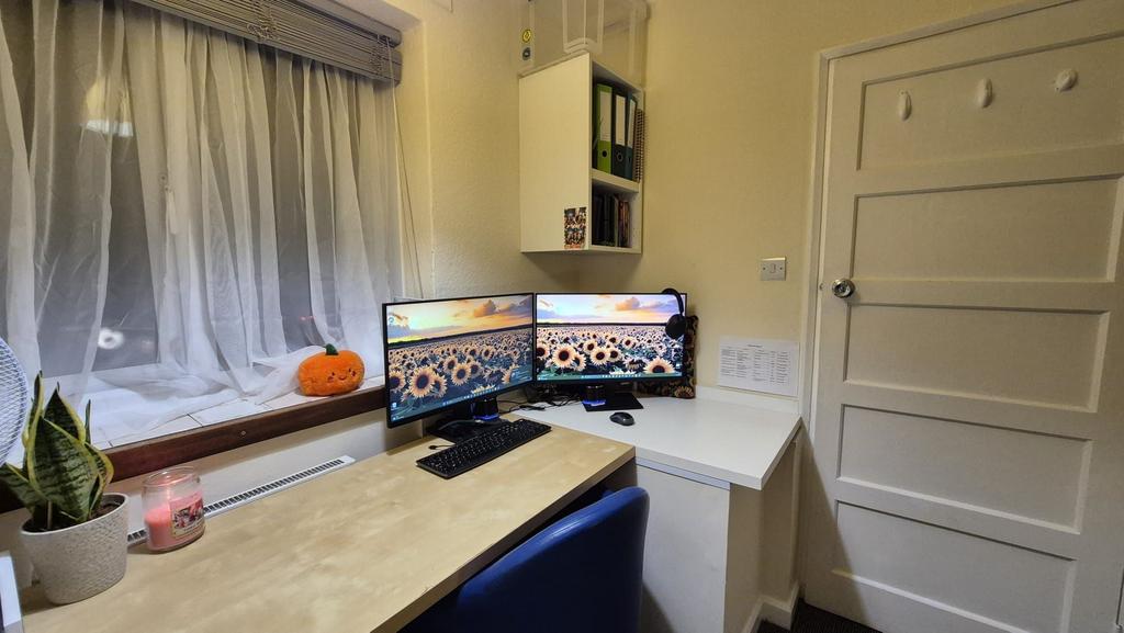Bright, tidy study workspace with dual monitors...