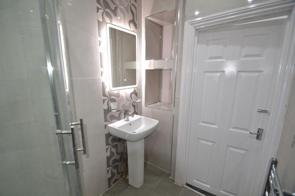 Modern tiled bathroom featuring a pedestal basi...