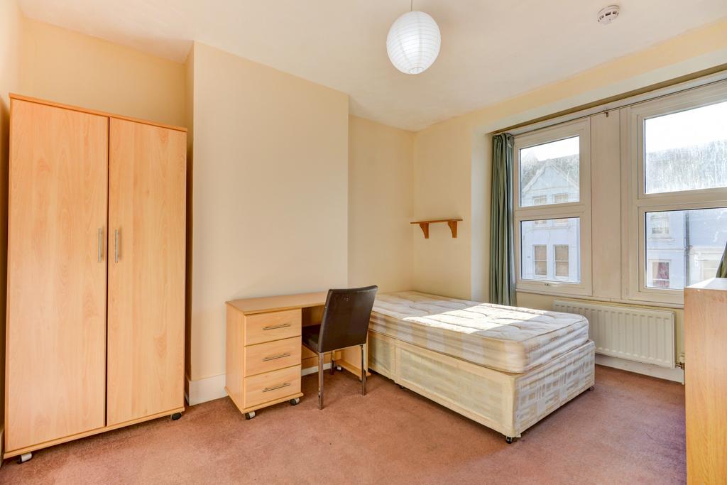 A bright and simple bedroom featuring a single ...