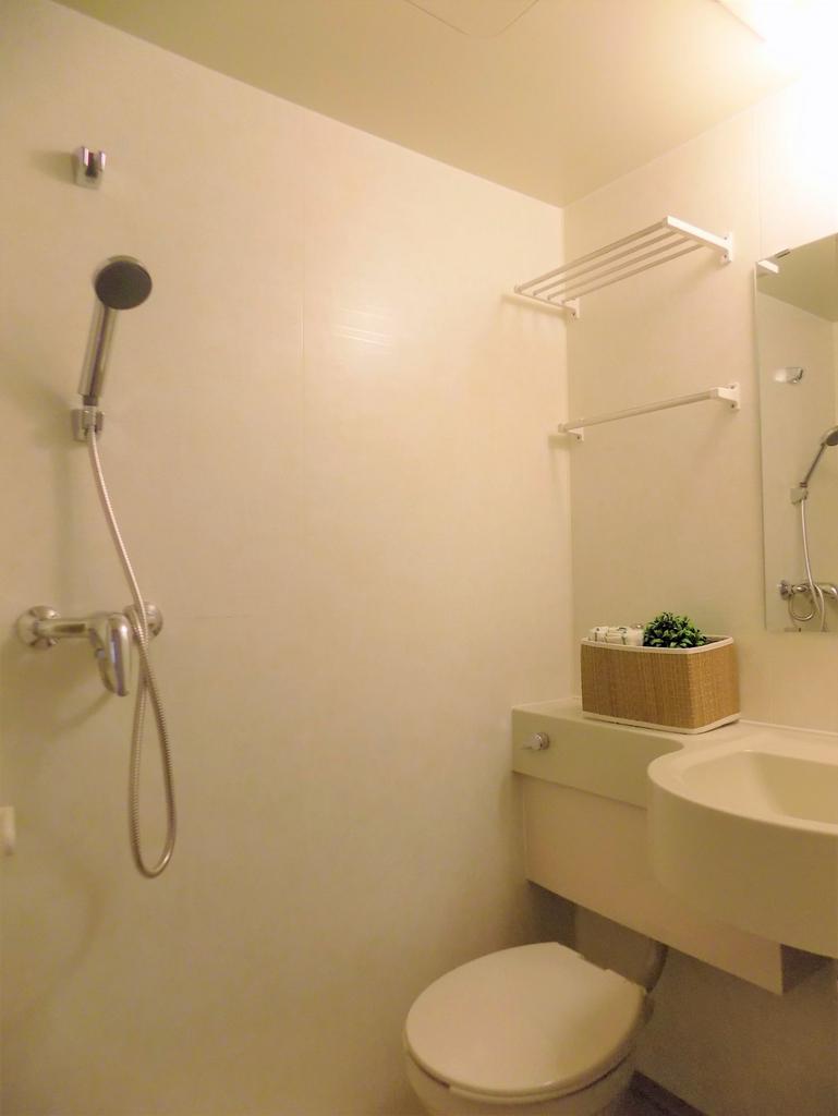 Minimal, well-kept bathroom with a wall-mounted...