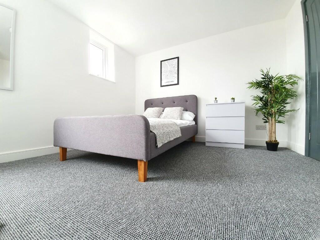 Bright and spacious master bedroom featuring a ...