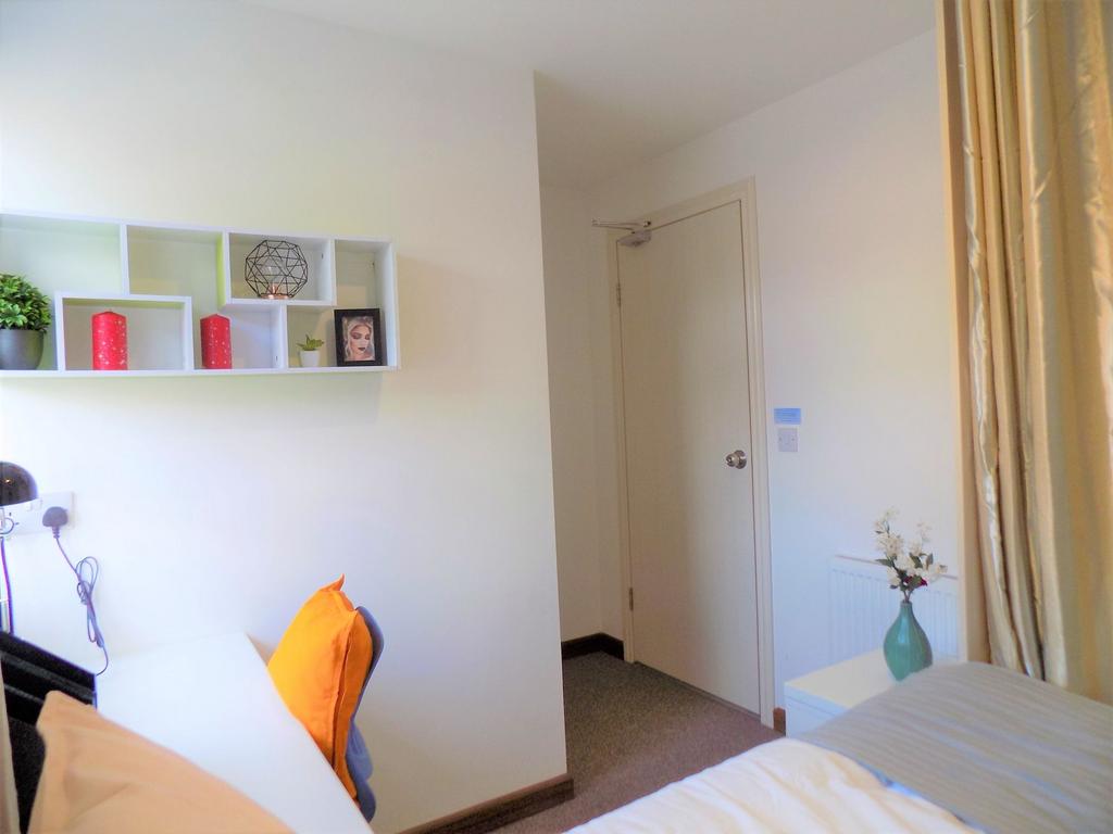 Bright, neatly styled bedroom with a cosy bed, ...