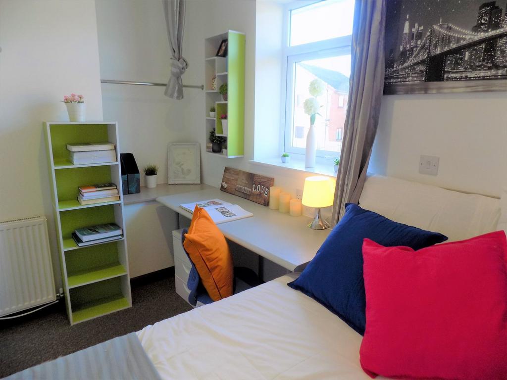 Bright, tidy bedroom with a cozy bed, colorful ...