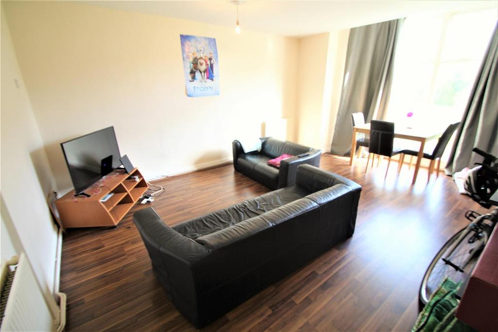 Bright and spacious living room with large wind...