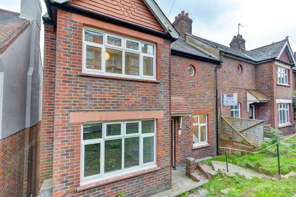 Brick-fronted terraced house with large bay win...