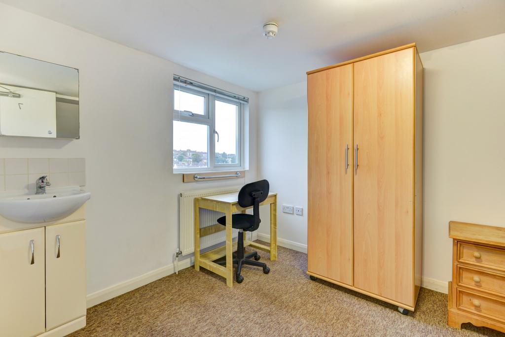 Neat single bedroom with a window providing nat...