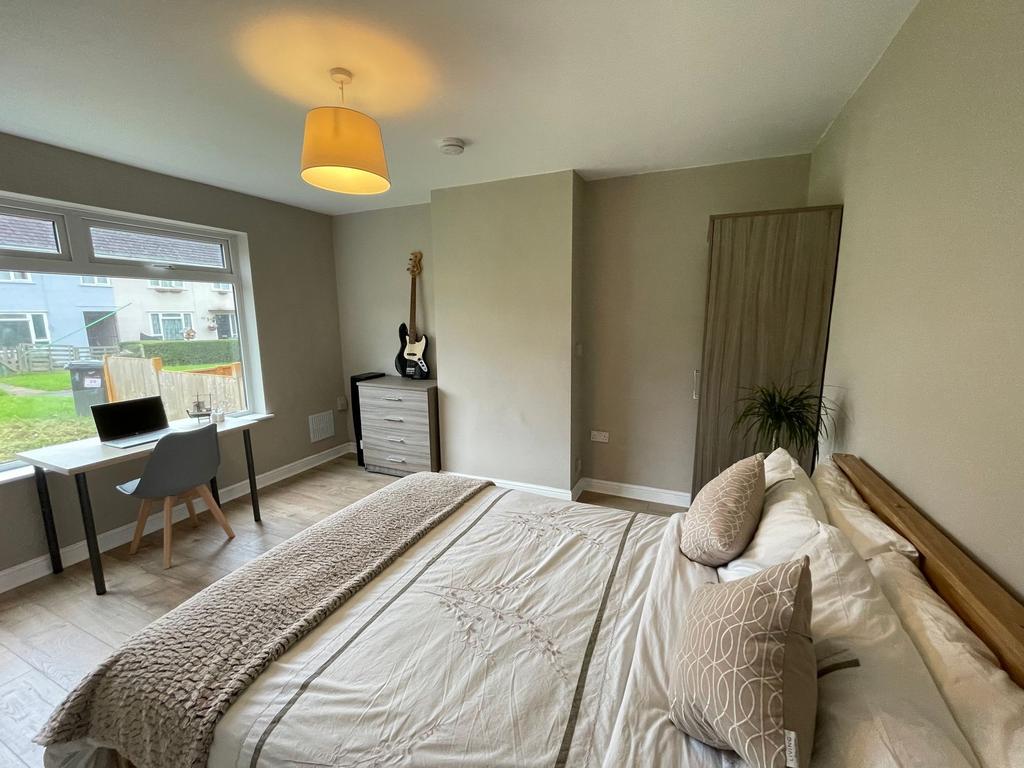 Bright and welcoming master bedroom featuring a...