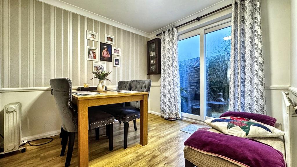 Bright, modern living/dining area with wood flo...