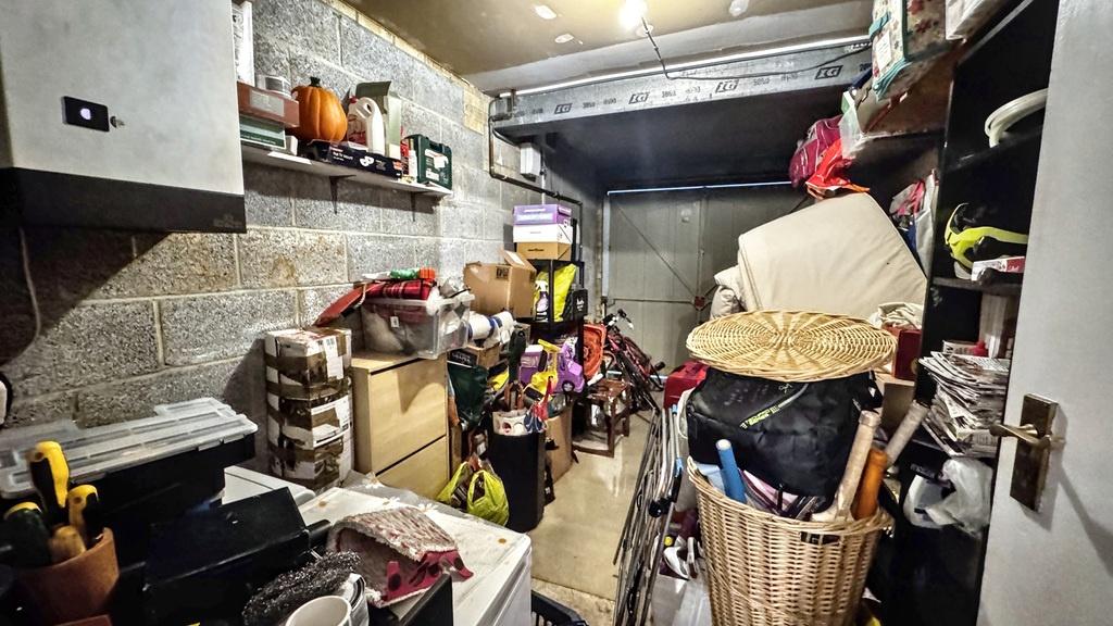A deep storage room packed with shelving and st...